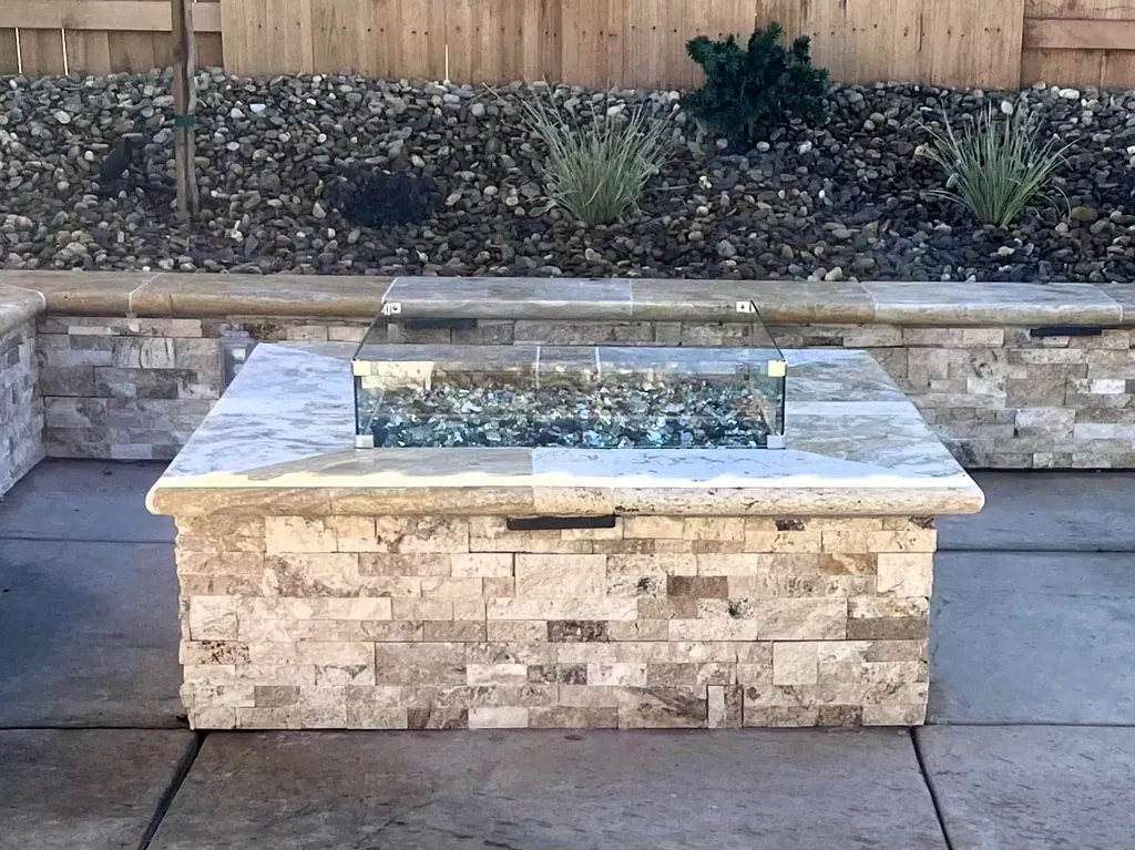 Rectangular fire table with a stone cap and stacked stone base
