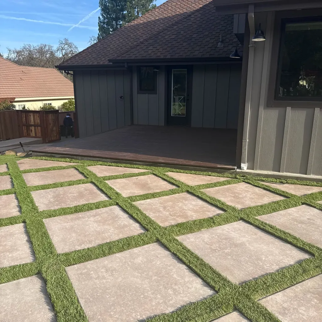 Large concrete pavers set in a diamond pattern with turf in the joints