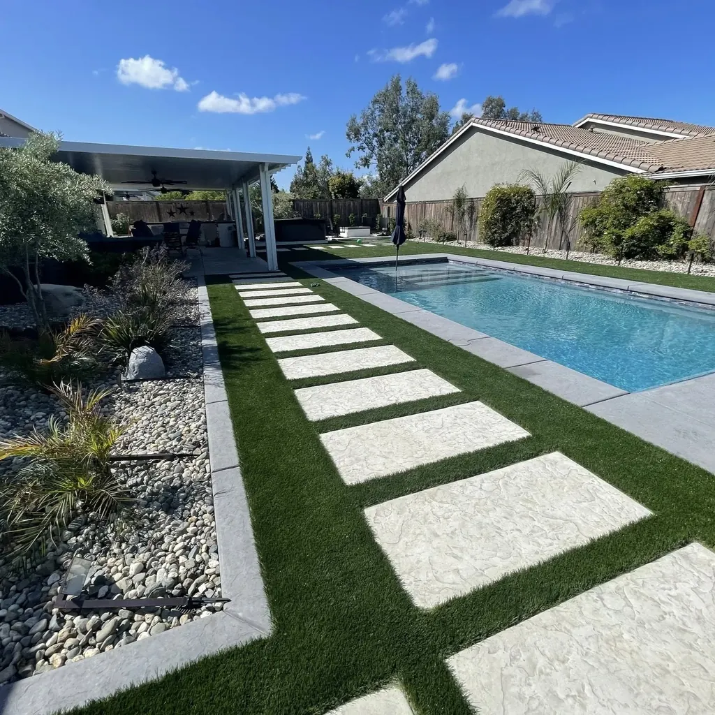 Large steppers set in turf leading to a pool