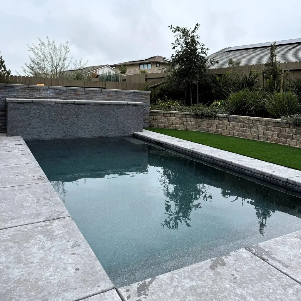 Rectangular pool with raised tile spillway and lawn